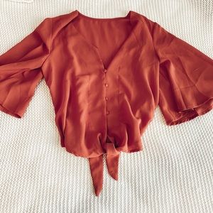 Button front blouse with tie detail at bottom